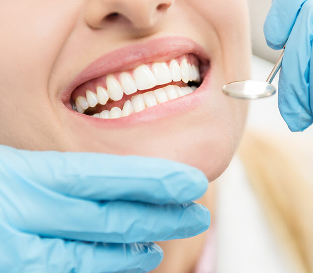 closeup of a dentist examining a patient's teeth