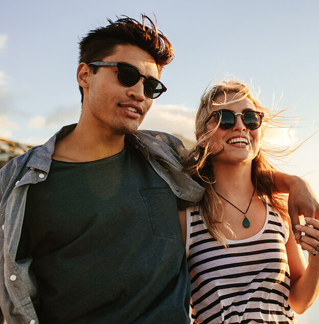 happy couple outside, wearing sunglasses