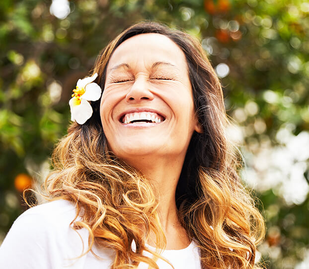 smiling woman with a flower in her hair