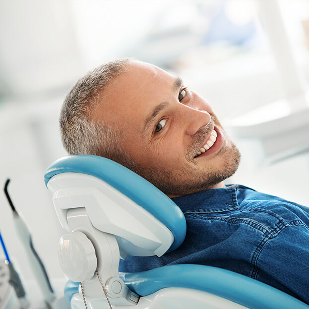 man in dental chair smiling