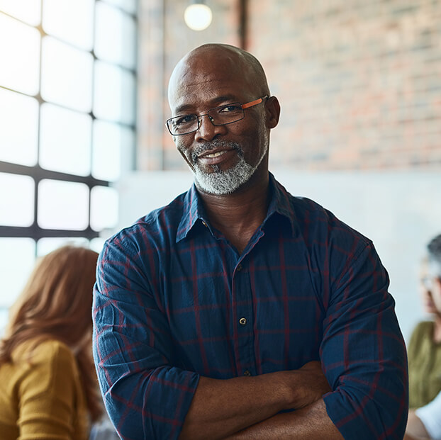 man smiling with his arms crossed