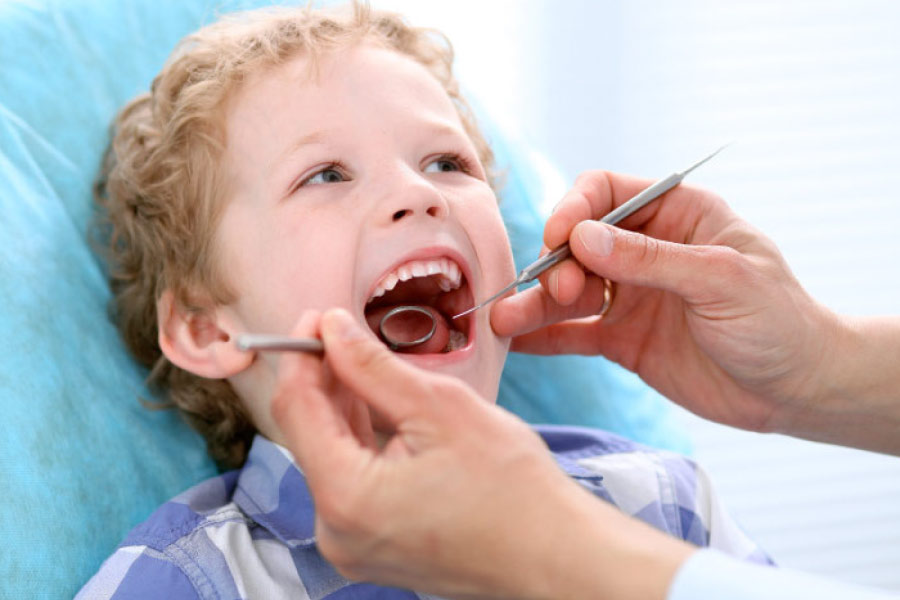 young boy getting a dental exam