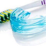 mouthguard sitting next to a toothbrush