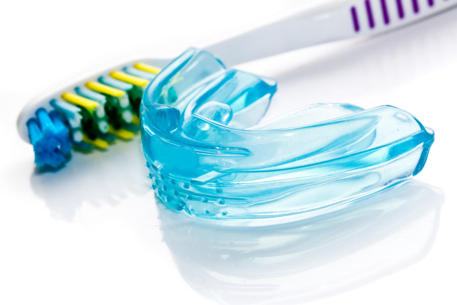 mouthguard sitting next to a toothbrush