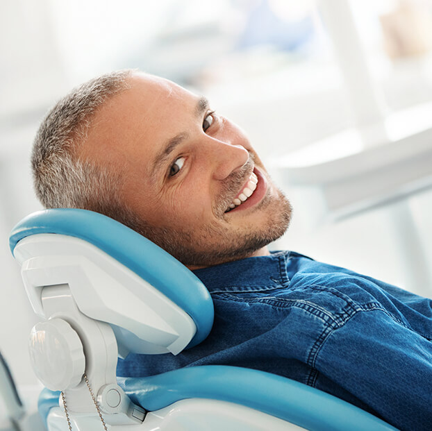 man smiling at dentist office